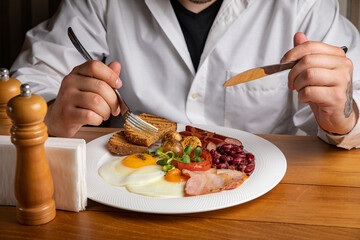 English breakfast on a wooden table in a restaurant
