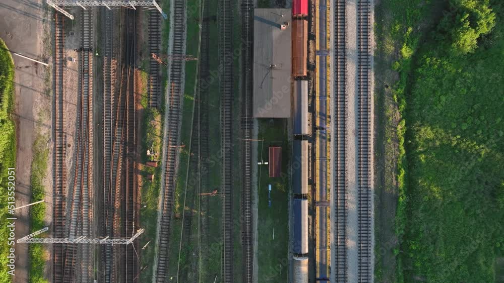Poster the view from the drone on the railroad tracks against the background of the setting sun. concept of
