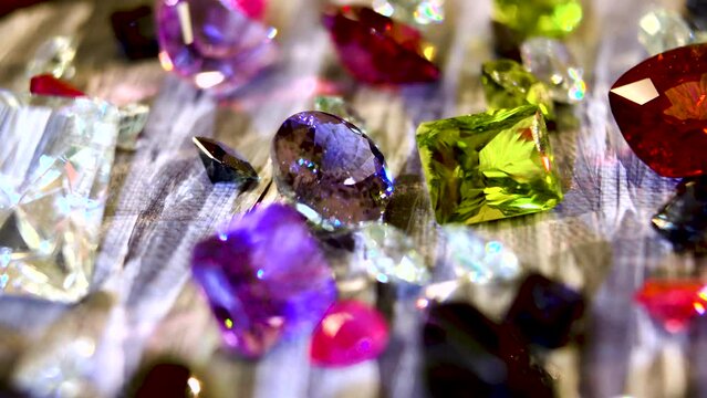 Close-up. Various Precious Jewelry Stones and Minerals: ruby, diamonds, emeralds, agate, amethyst, sapphire, topaz, tourmaline, aquamarine