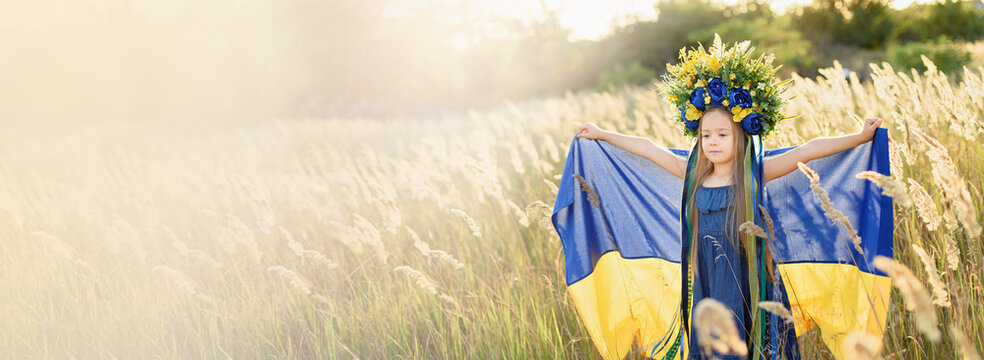 Ukraines Independence Flag Day. Constitution day. Ukrainian child girl with yellow and blue flag of Ukraine in field. flag symbols of Ukraine. Kyiv, Kiev day