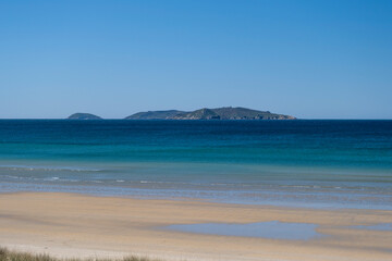 Fototapeta na wymiar Sandy beach with islands views