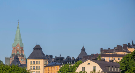 Fototapeta premium Panorama view with roofs and church tower in the district Södermalm a sunny summer day in Stockholm