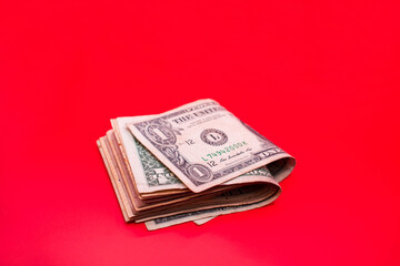 Fajo de billetes de un dolar en un fondo rojo aislado 