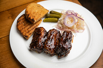 Food. Grilled Meat And Vegetables With Sauce Closeup. Grilles Pork Ribs In Restaurant.