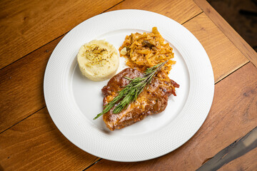 Steak with garnish and sauce on a plate
