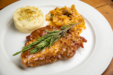 Steak with garnish and sauce on a plate
