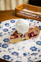 Cherry Clafoutis with ice cream on a plate

