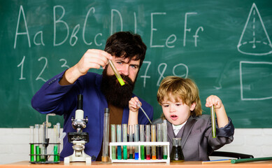 Genius child private lesson. Knowledge day. Genius minds. Genius kid. Joys and challenges raising gifted child. Teacher bearded scientist man child test tubes. Chemical experiment. Special and unique