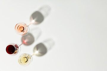 Wine composition with beautiful sunlight and shadows on white background