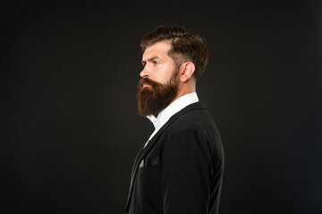 serious man in tuxedo bow tie. man profile in formalwear on black background. male formal fashion