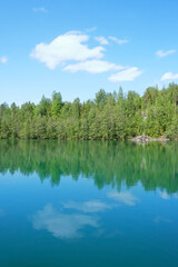 Beautiful blue lake, green forest and blue sky. Lakeshore Summer peaceful landscape in sunny day. scenic minimal view. Northern nature of Karelia