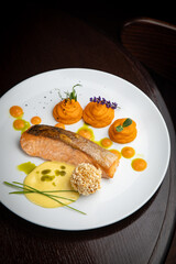 Fish dish with garnish on a plate in a restaurant
