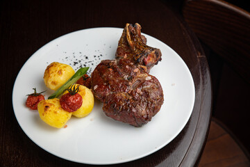 steak with  potatoes and cherries on a plate