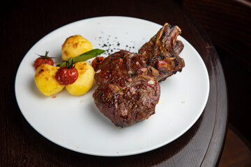 steak with  potatoes and cherries on a plate
