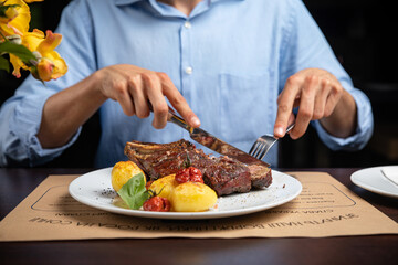 steak with  potatoes and cherries on a plate