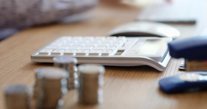 Female hands using calculator carry out calculation for laptop calculates expenses