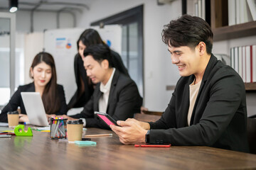 Asian businessman looking at the camera Working and meeting at the office at the company with colleagues at the back