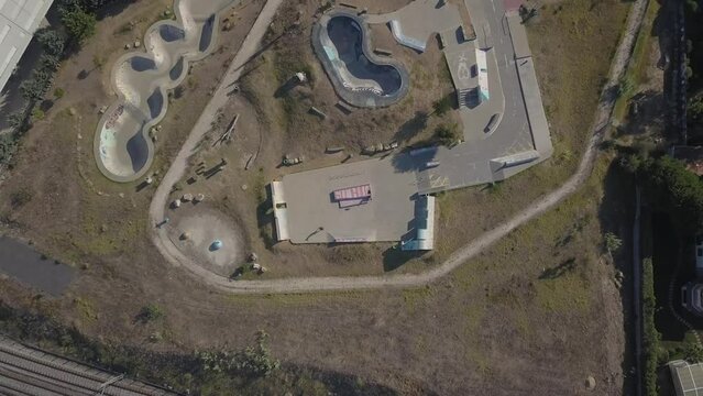 Vertical Drone Shot Of The Skatepark Parque Das Gerações In Cascais Portugal. Takes Overhead Where We Can See The Skate Park With Some Riders Skating The Ramps And Enjoying A Wonderful Sunrise.