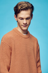 man posing on a blue background looking away