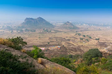 Fototapeten Joychandi Pahar - mountain - is a hill which is a popular tourist attraction in the Indian state of West Bengal in Purulia district. View of Purulia from the top of the hill in daytime with blue sky. © mitrarudra