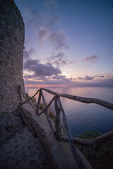 Old brick tower by the sea with sunset