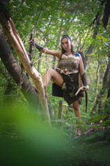 Beautiful asian woman an archer with the bow is hunting in the forest concept.