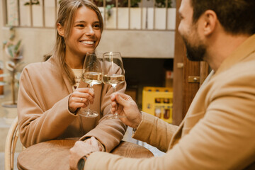 White romantic couple drinking wine during date in cafe