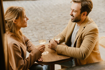 White romantic couple drinking wine during date in cafe