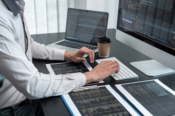 Male programmer working on website project in software development on the desktop computer and...
