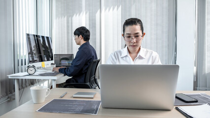 Fototapeta premium Team of two professional programmers working on website projects in software development and making coding and typing data code password security in office