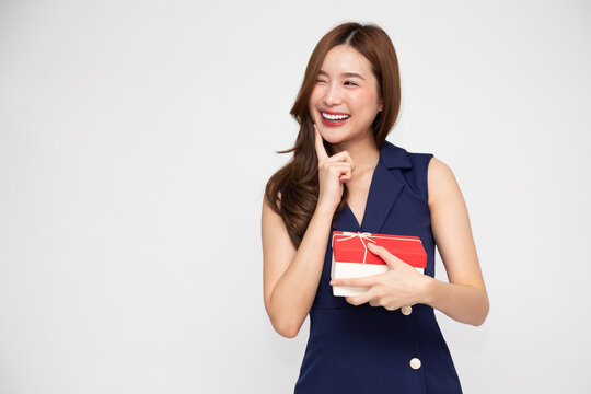 Happy Asian woman holding red gift box isolated on white background, Valentine day or Happy birthday concept