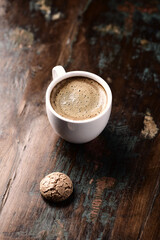 Cup of coffee with Amaretti (Italian biscuit) on rustic wooden background. Copy space.