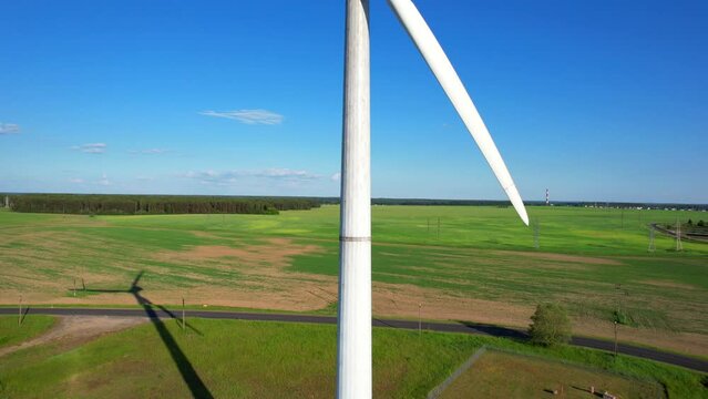 Panoramic shot from a bird's eye view of wind turbines in the middle of fields. Wind turbine construction in green field blue sky to generate renewable clean energy. concept idea eco energy energy.
