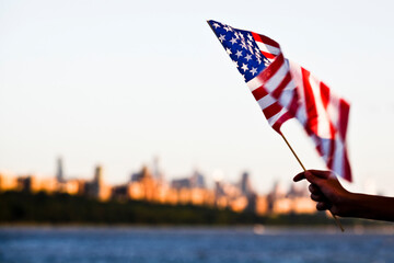 American flag during Independence Day on the Hudson River with a view at Manhattan - New York City...