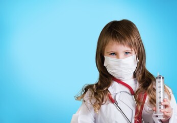 Girl child in laboratory gown, with a stethoscope, acting like medical practitioners such as doctor, nurse or caregiver to show the benefit of science