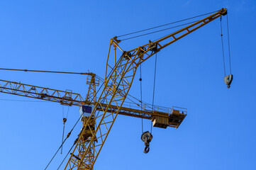 New construction site with cranes on sunset background.