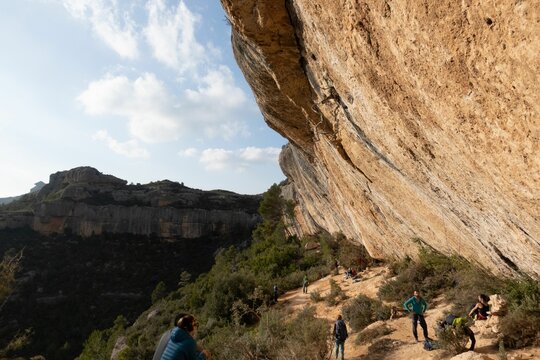 Beautiful view of people climbing rocks on a sunny day in Margalef, Spain
