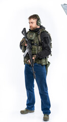 soldier, airsoft player in full gear with a machine gun. a man in headphones, a bulletproof vest, with a backpack and a full-length belt. White background.