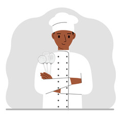 Smiling chef holds a kitchen cutlery set in his hand. profession.