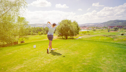 Golfer sport course golf ball fairway. People lifestyle woman playing game golf and hitting go on...