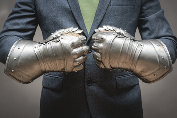 Businessman hands in the plate armor mittens close up. Help of a lawyer. Business protection...
