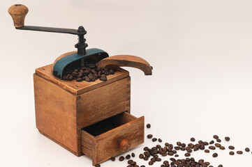 Old wooden coffee grinder with coffee beans in Landscape format