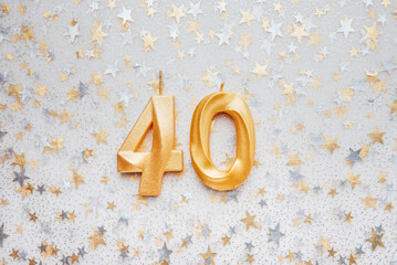 Number 40 fourty golden celebration birthday candle on Festive Background. fourty years birthday. concept of celebrating birthday, anniversary, important date, holiday