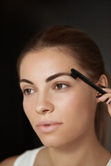 Obraz premium Beauty makeup. Eyebrows Care and makeup. Portrait of beautiful woman model shaping brown eyebrows.