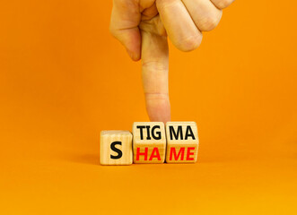 Stigma or shame symbol. Concept words Stigma or Shame on wooden cubes. Businessman hand. Beautiful orange table orange background. Business stigma or shame concept. Copy space.