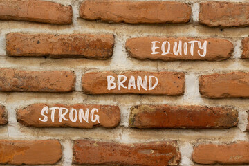 Strong brand equity symbol. Concept words Strong brand equity on red bricks on a beautiful brick...
