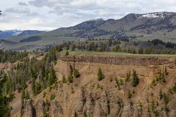 Red Rock Cliff and Mountains in American Landscape. Yellowstone National Park. United States. Nature Background.