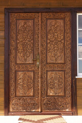Fototapeta na wymiar wooden door decorated with islamic wood carvings