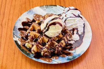 waffle with chocolate, cream and vanilla ice cream