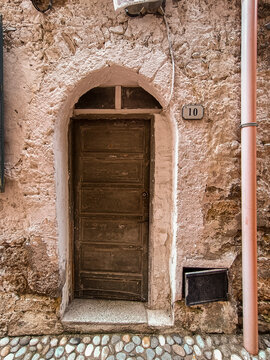Local architecture and details of houses in the medieval old town of Ventimiglia in Italy, Liguria in the province of Imperia. Vintage door in an old house